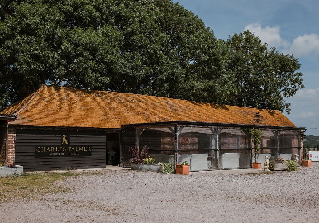 Cellar door with 'Charles Palmer' branding under a clear sky